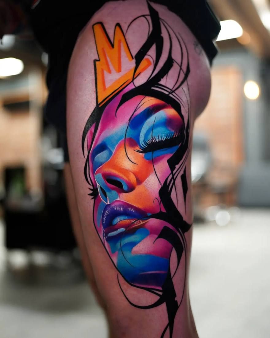 Colour realism tattoo by Starletink: abstract face in blue, pink and orange with a crown